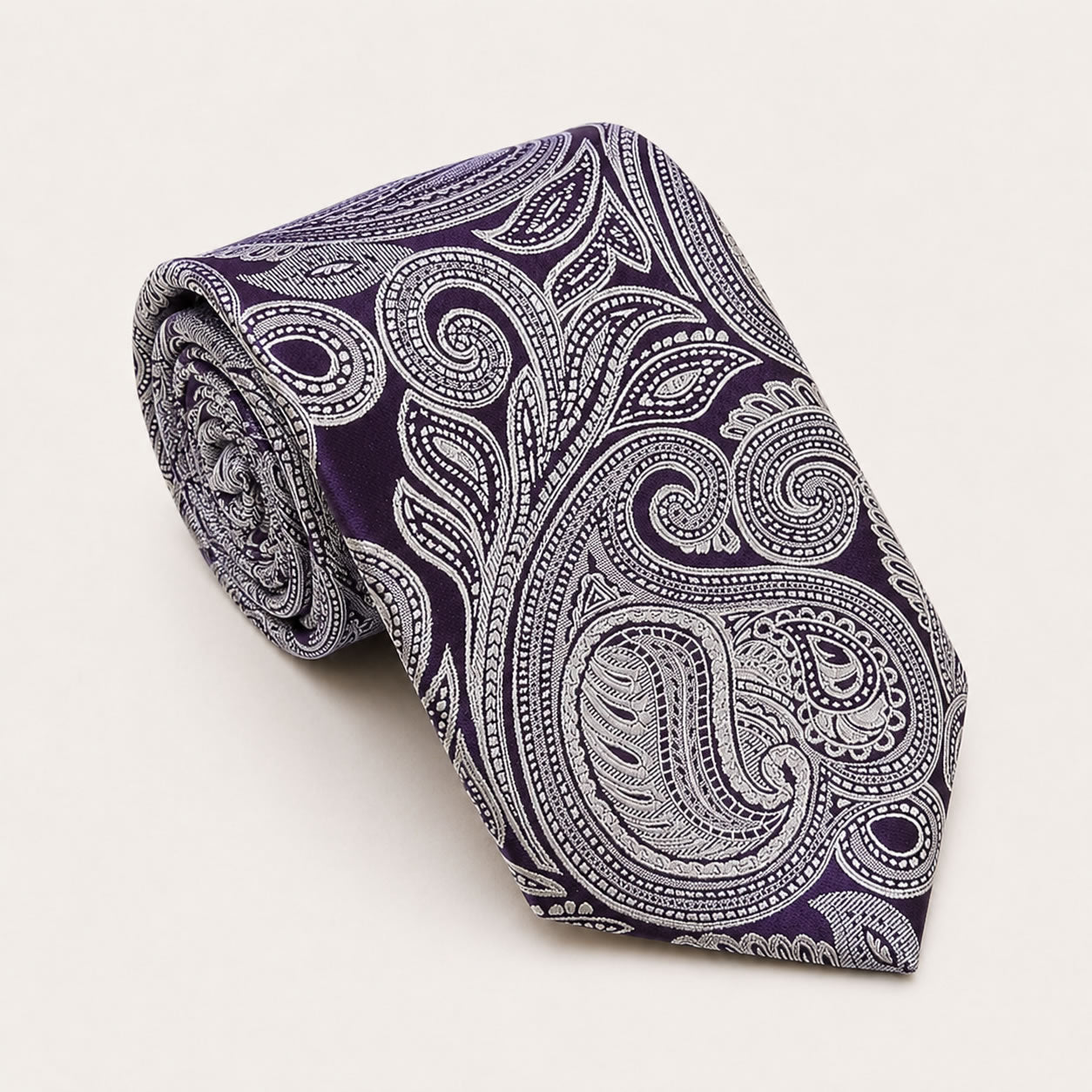 A rolled George Neale purple paisley silk tie.