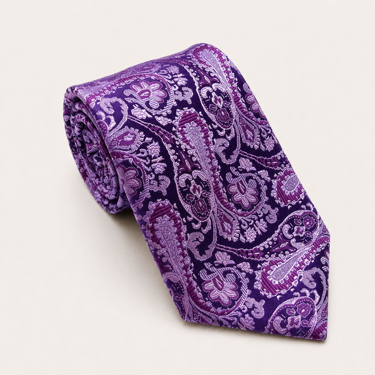 A rolled George Neale purple paisley silk tie.