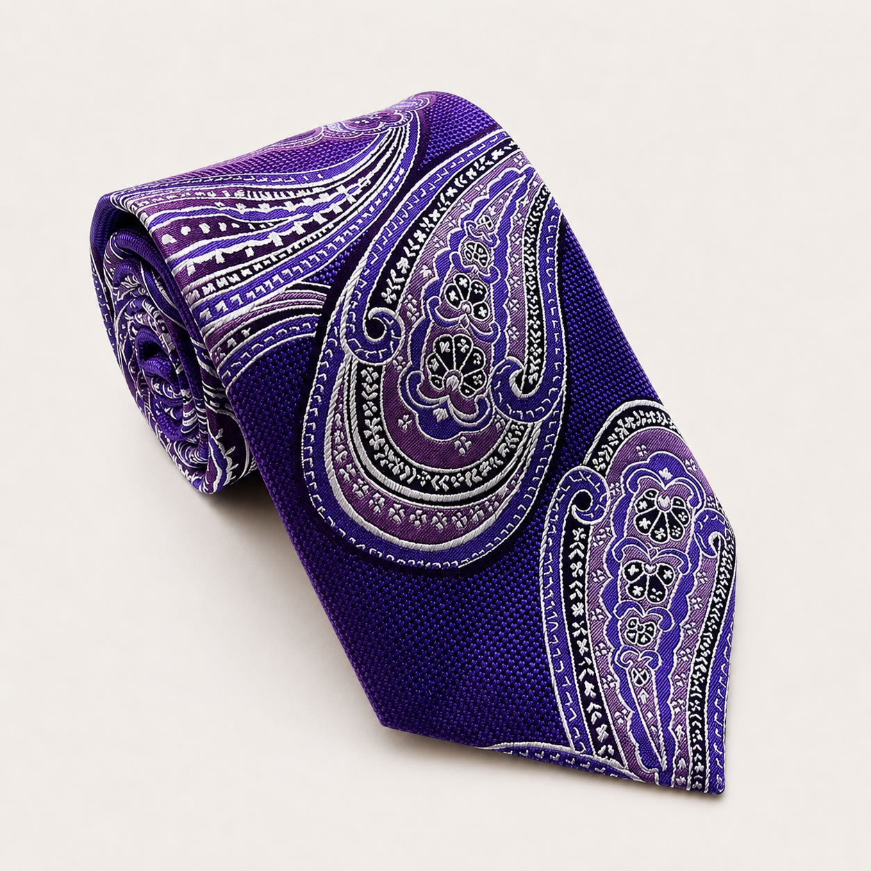 A rolled George Neale purple paisley silk tie.