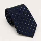A rolled George Neale navy and gold polka dot silk tie.