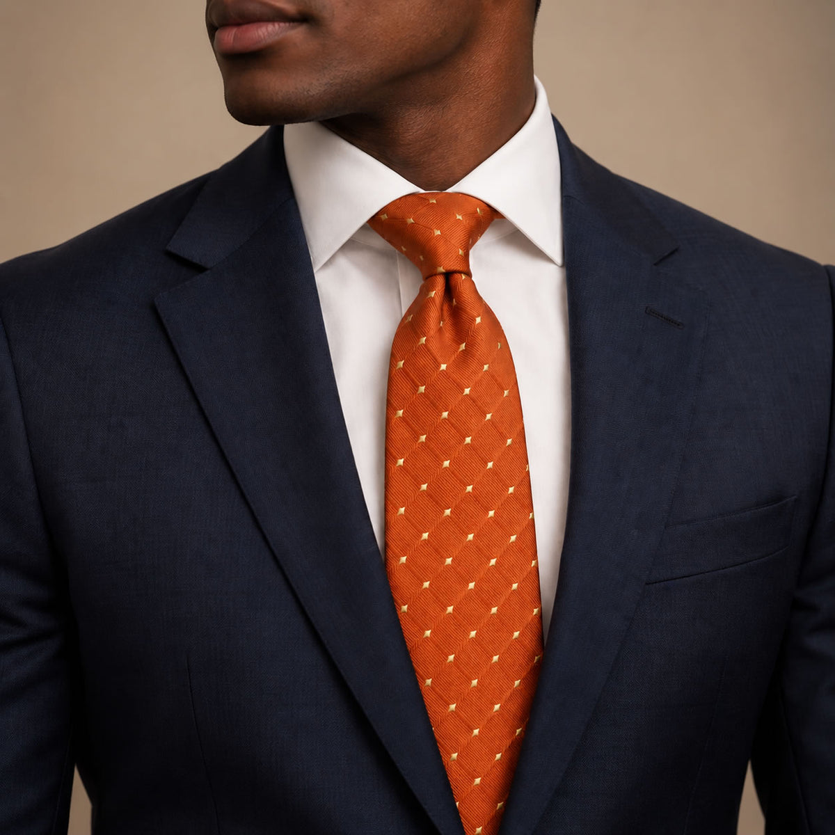 Orange and Gold Polka Dot Silk Tie by George Neale, worn by a model with a suit and shirt
