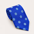 A rolled George Neale blue polka dot silk tie.