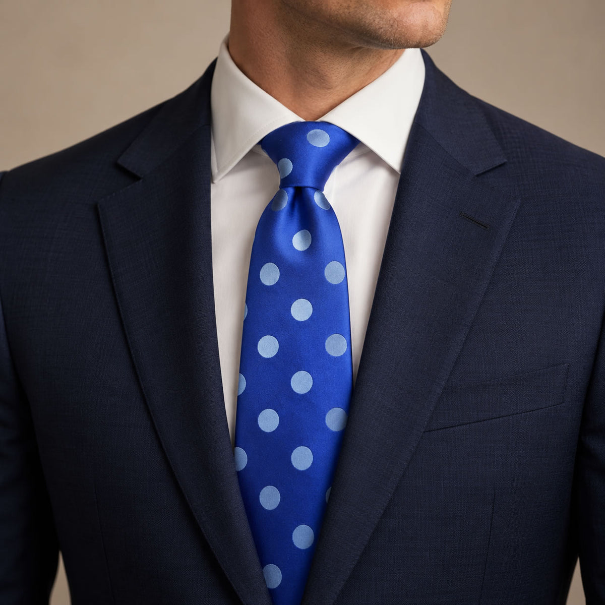 Blue Polka Dot Silk Tie by George Neale, worn by a model with a suit and shirt
