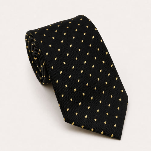 A rolled George Neale black and gold polka dot silk tie.