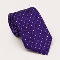 A rolled George Neale purple and gold polka dot silk tie.