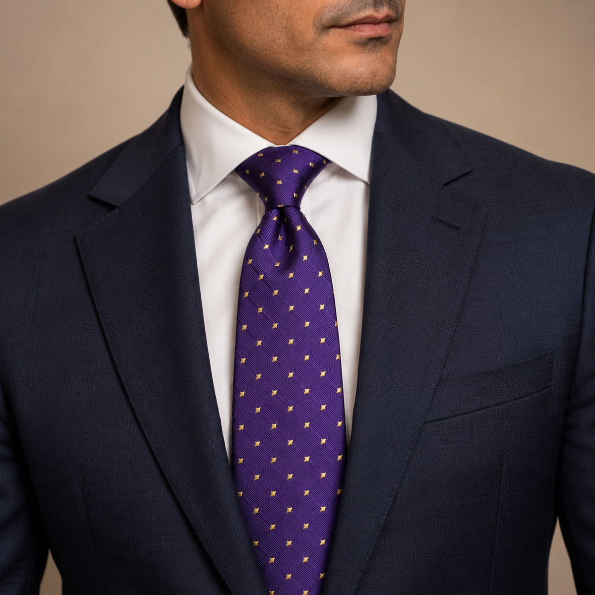 Purple and Gold Polka Dot Silk Tie by George Neale, worn by a model with a suit and shirt