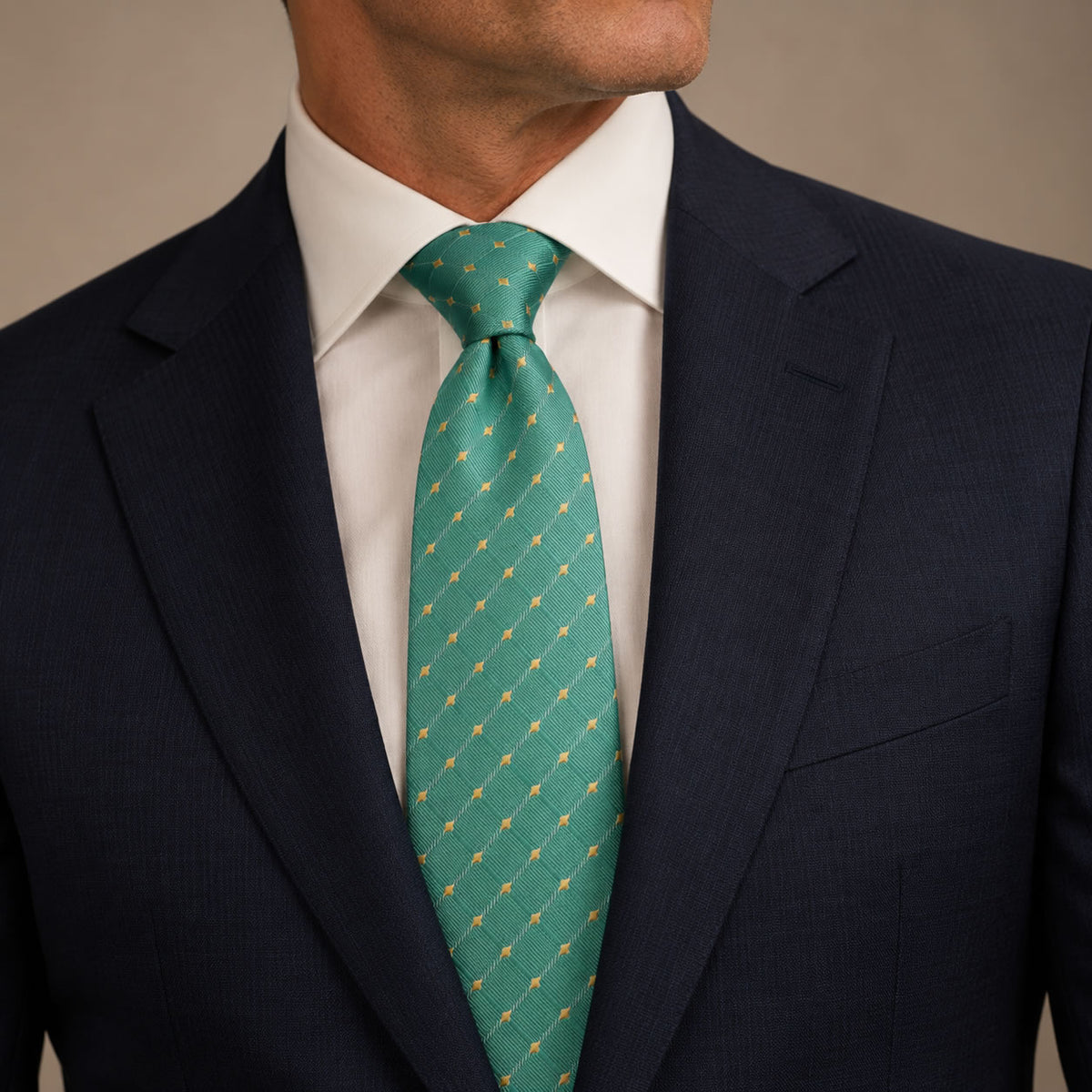 Aquamarine and Gold Polka Dot Silk Tie by George Neale, worn by a model with a suit and shirt