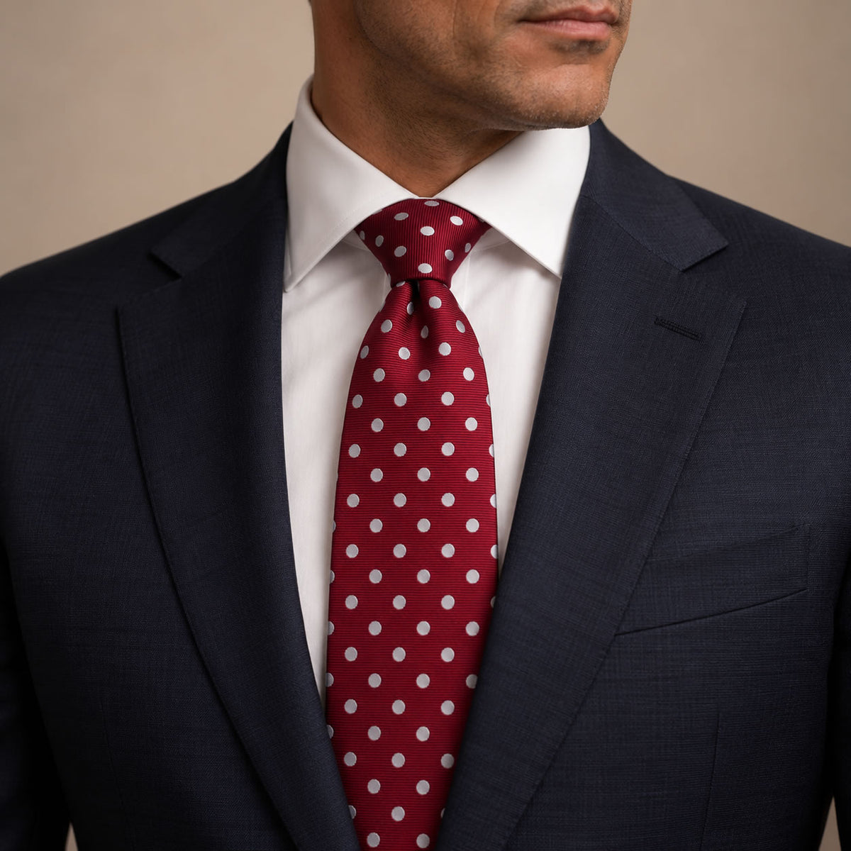 Red and White Polka Dot Silk Tie by George Neale, worn by a model with a suit and shirt