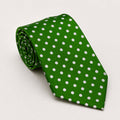 A rolled George Neale green and white polka dot silk tie.