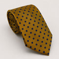 A rolled George Neale gold and navy polka dot silk tie.