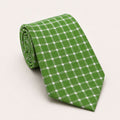 A rolled George Neale green and silver polka dot silk tie.