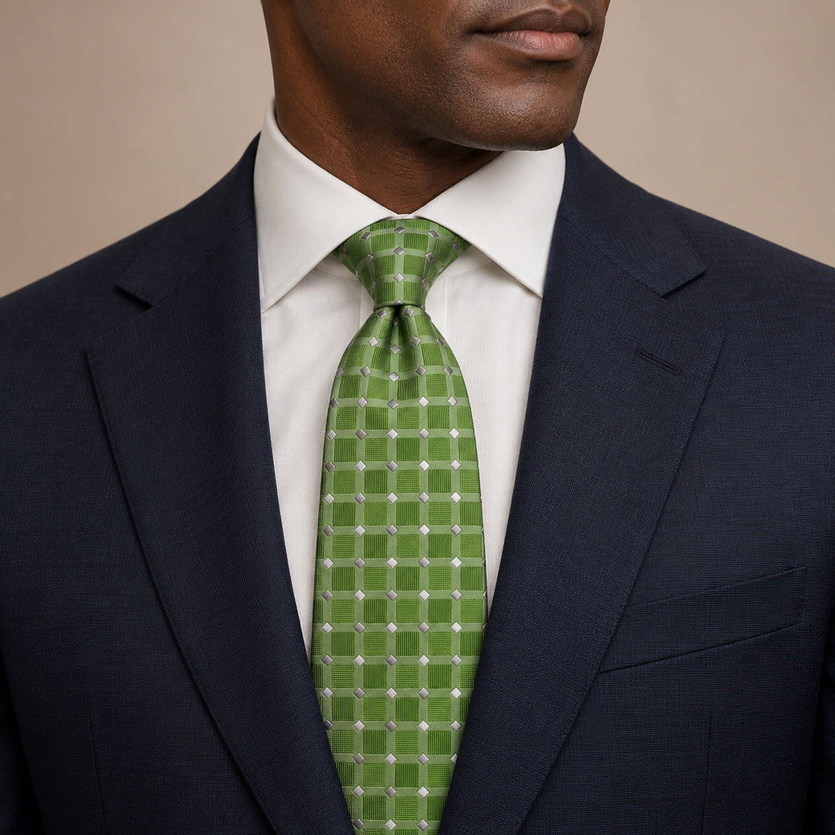 Green and Silver Polka Dot Silk Tie by George Neale, worn by a model with a suit and shirt