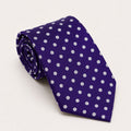 A rolled George Neale purple and white polka dot silk tie.
