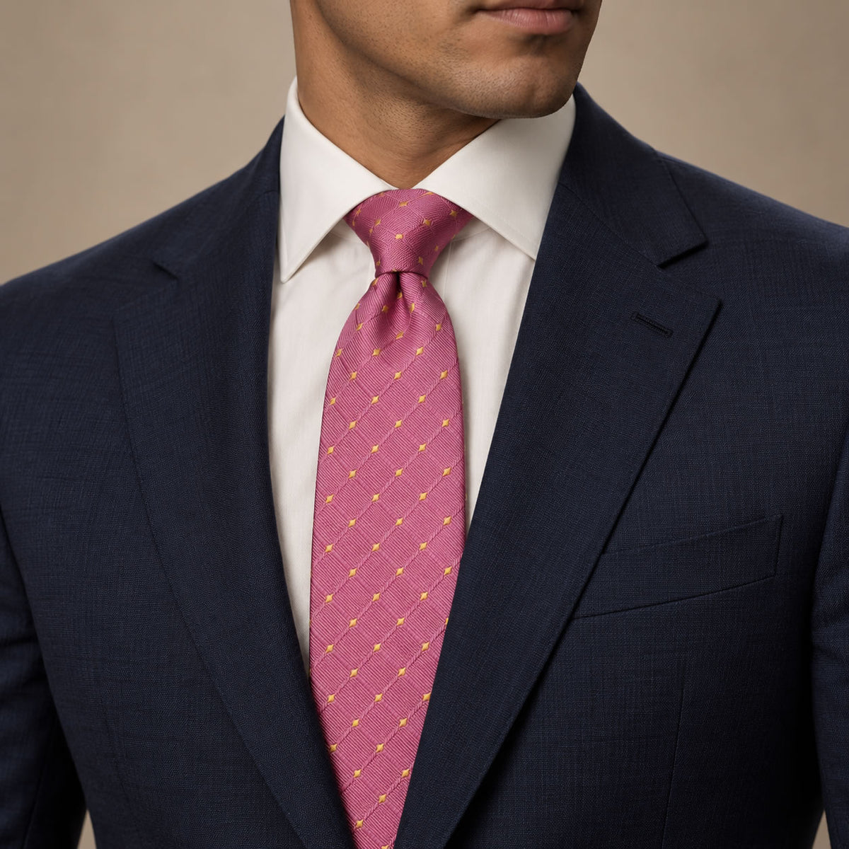 Pink and Gold Polka Dot Silk Tie by George Neale, worn by a model with a suit and shirt