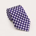 A rolled George Neale purple and white polka dot silk tie.