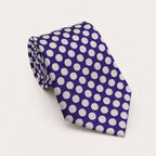 A rolled George Neale purple and white polka dot silk tie.