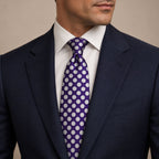 Purple and White Polka Dot Silk Tie by George Neale, worn by a model with a suit and shirt
