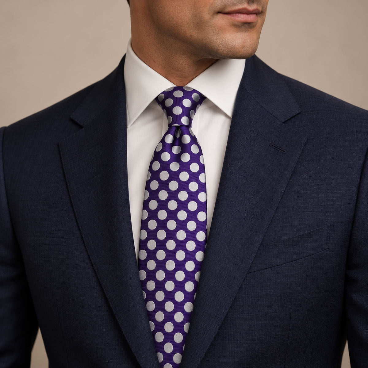 Purple and White Polka Dot Silk Tie by George Neale, worn by a model with a suit and shirt