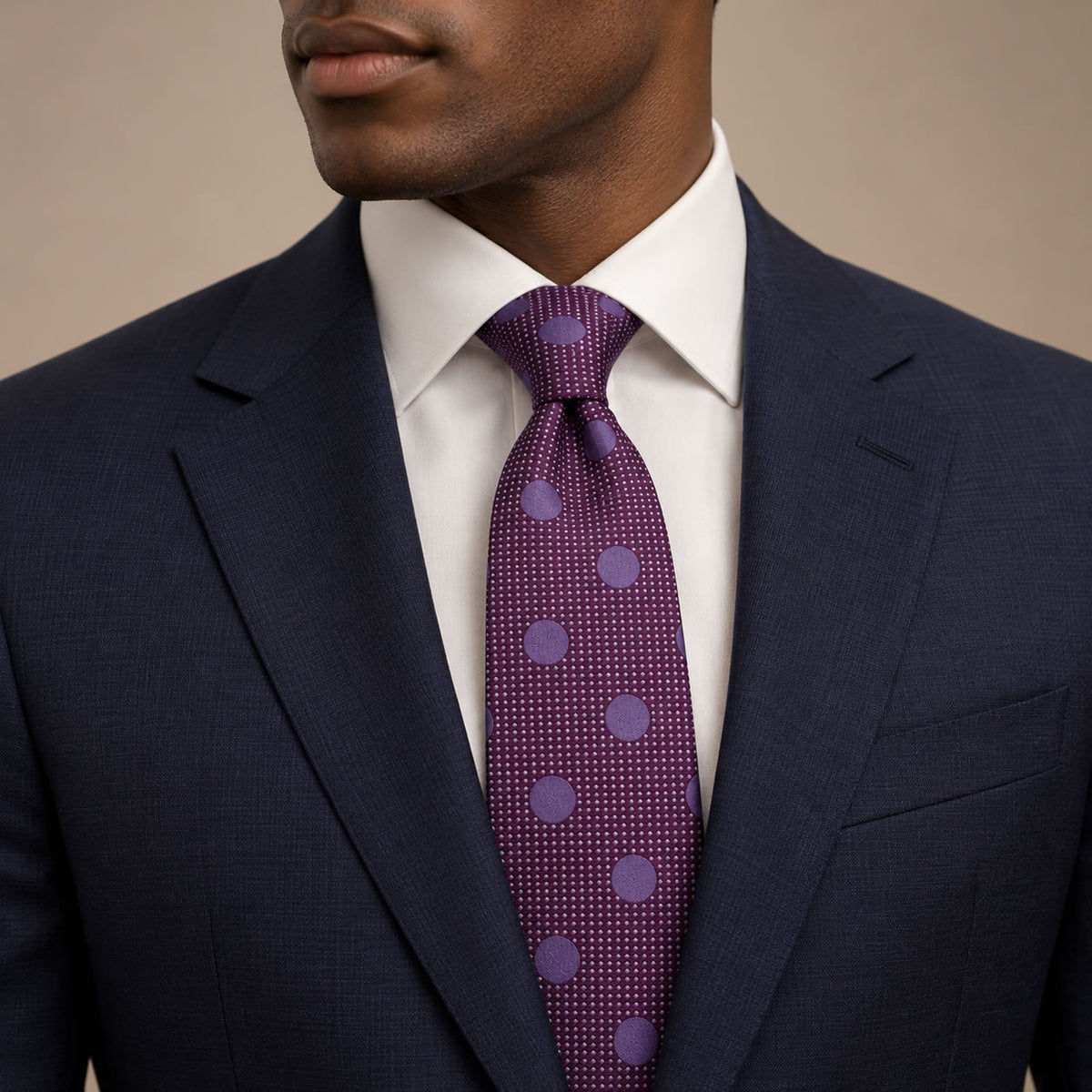 Purple Polka Dot Silk Tie by George Neale, worn by a model with a suit and shirt
