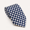A rolled George Neale navy and white polka dot silk tie.