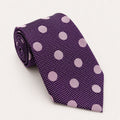 A rolled George Neale purple and pink polka dot silk tie.