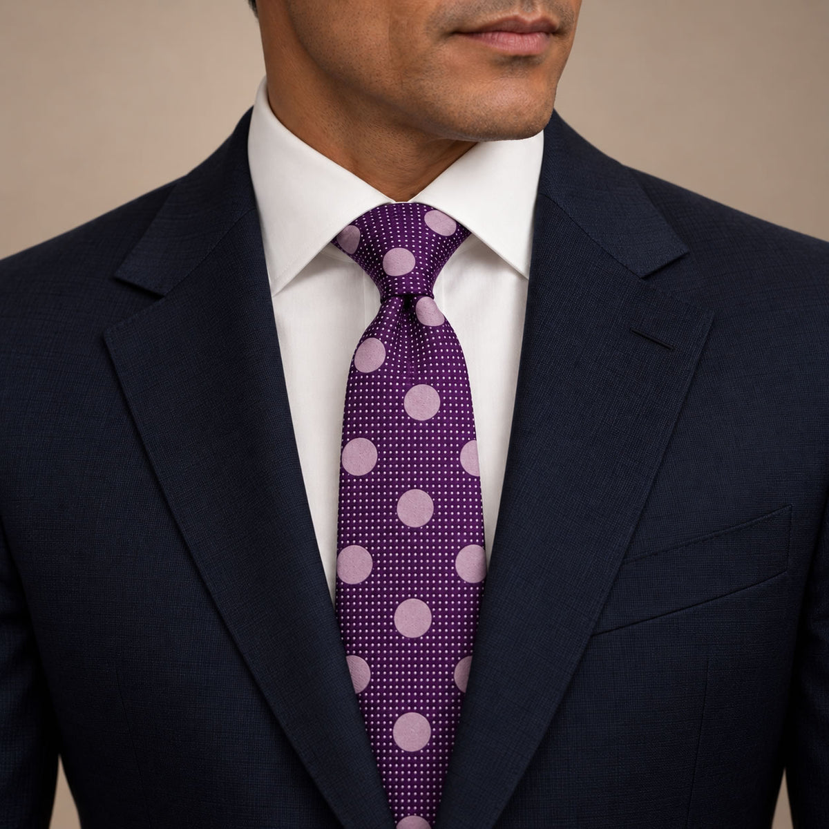 Purple and Pink Polka Dot Silk Tie by George Neale, worn by a model with a suit and shirt