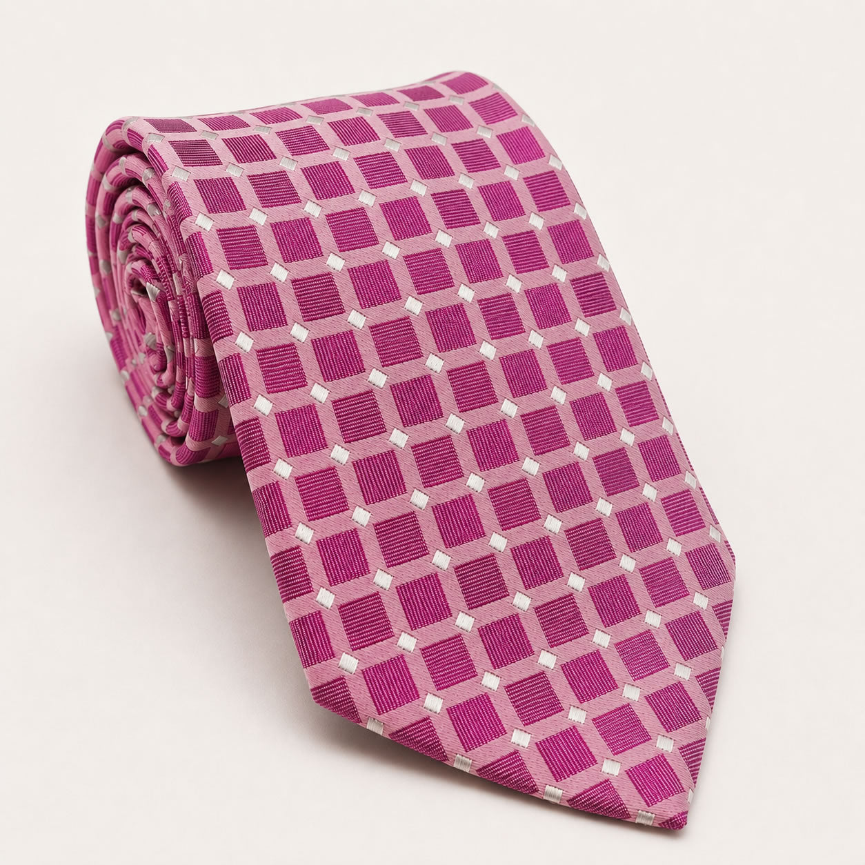 A rolled George Neale pink and silver polka dot silk tie.