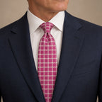 Pink and Silver Polka Dot Silk Tie by George Neale, worn by a model with a suit and shirt