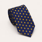 A rolled George Neale navy and gold polka dot silk tie.