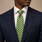 Dark Green and White Polka Dot Silk Tie by George Neale, worn by a model with a suit and shirt