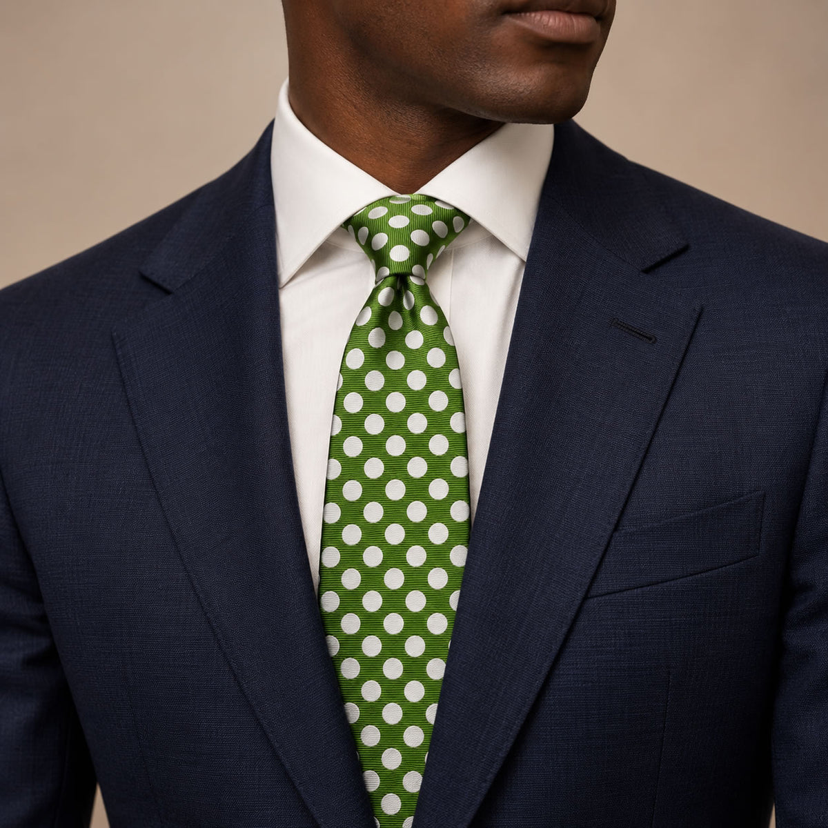 Dark Green and White Polka Dot Silk Tie by George Neale, worn by a model with a suit and shirt