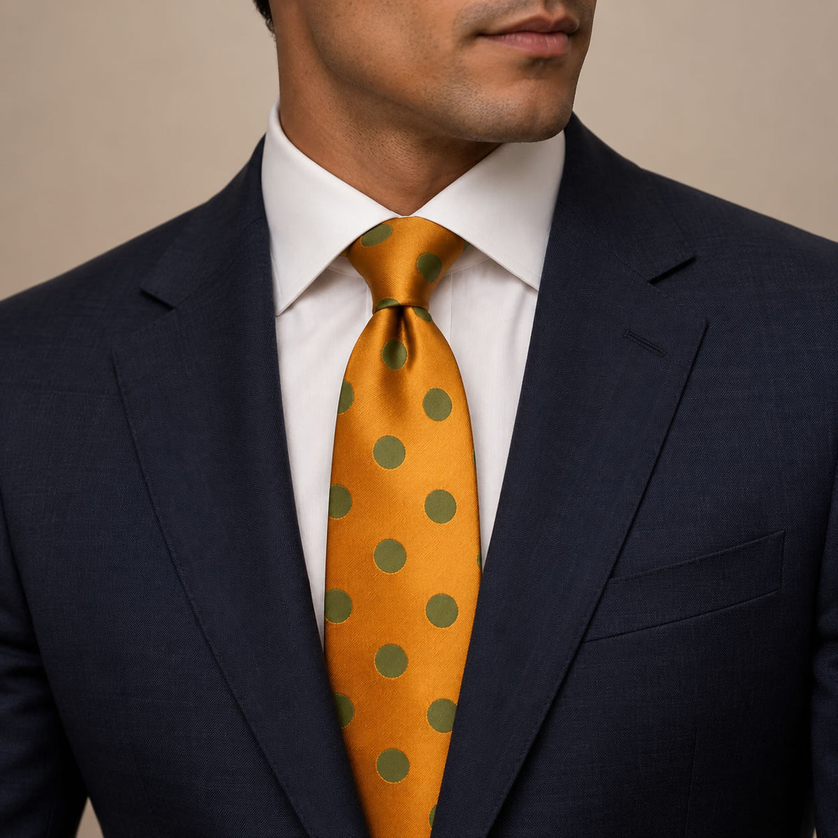 Orange and Olive Green Polka Dot Silk Tie by George Neale, worn by a model with a suit and shirt
