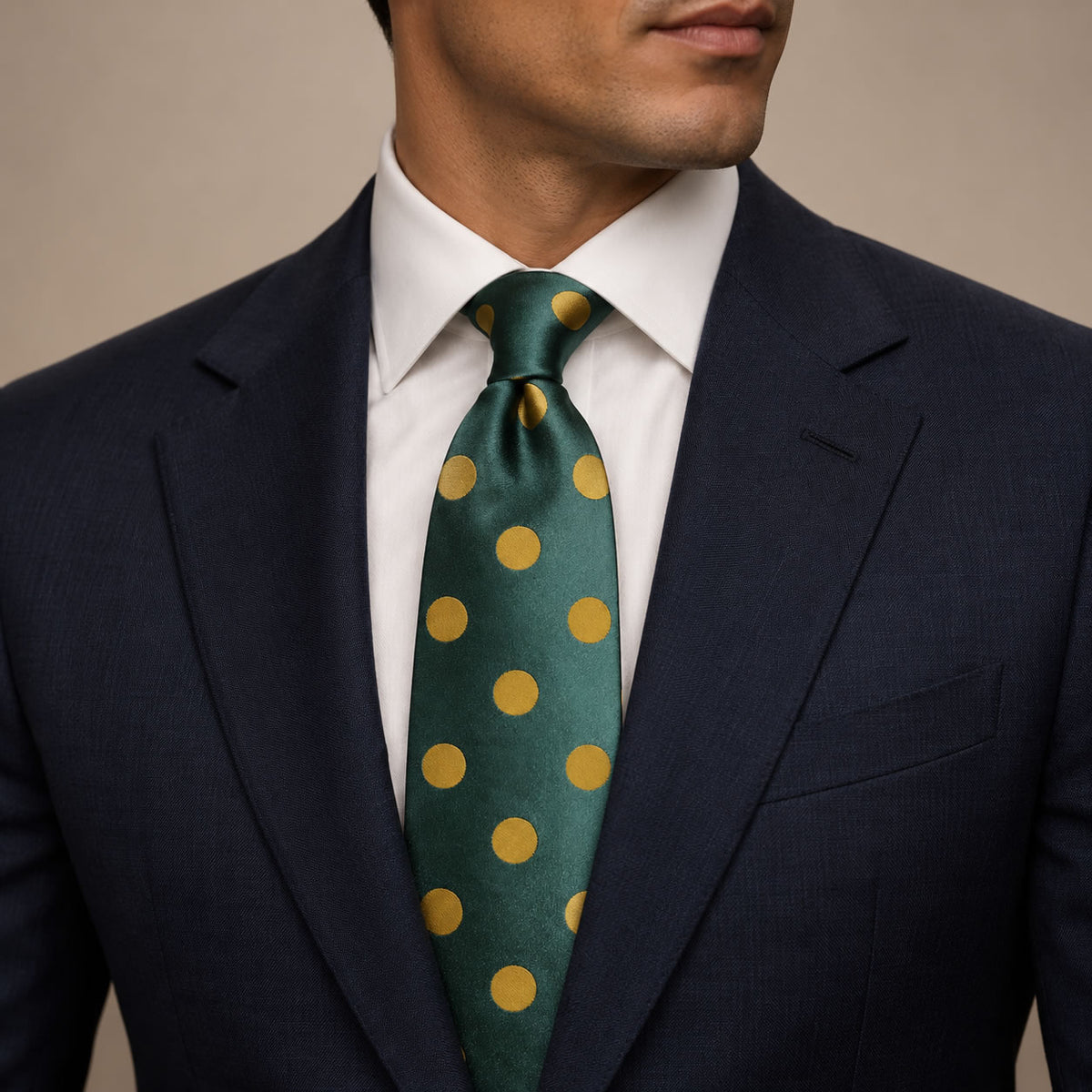 Forest Green and Gold Polka Dot Silk Tie by George Neale, worn by a model with a suit and shirt