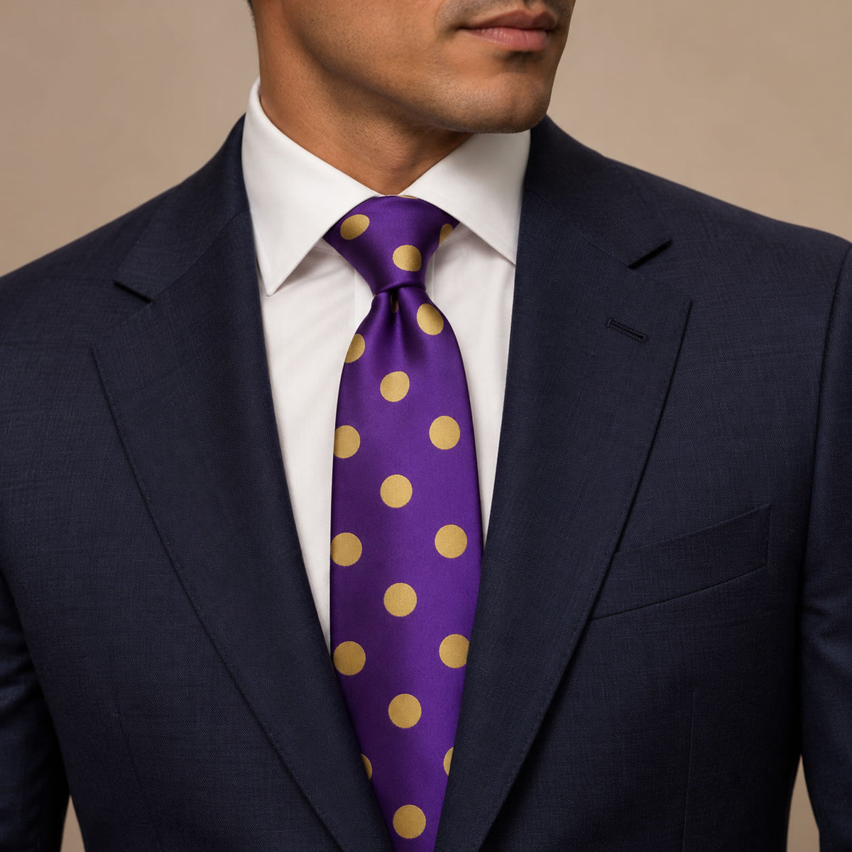 Purple and Gold Polka Dot Silk Tie by George Neale, worn by a model with a suit and shirt