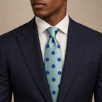 Blue Polka Dot Silk Tie by George Neale, worn by a model with a suit and shirt