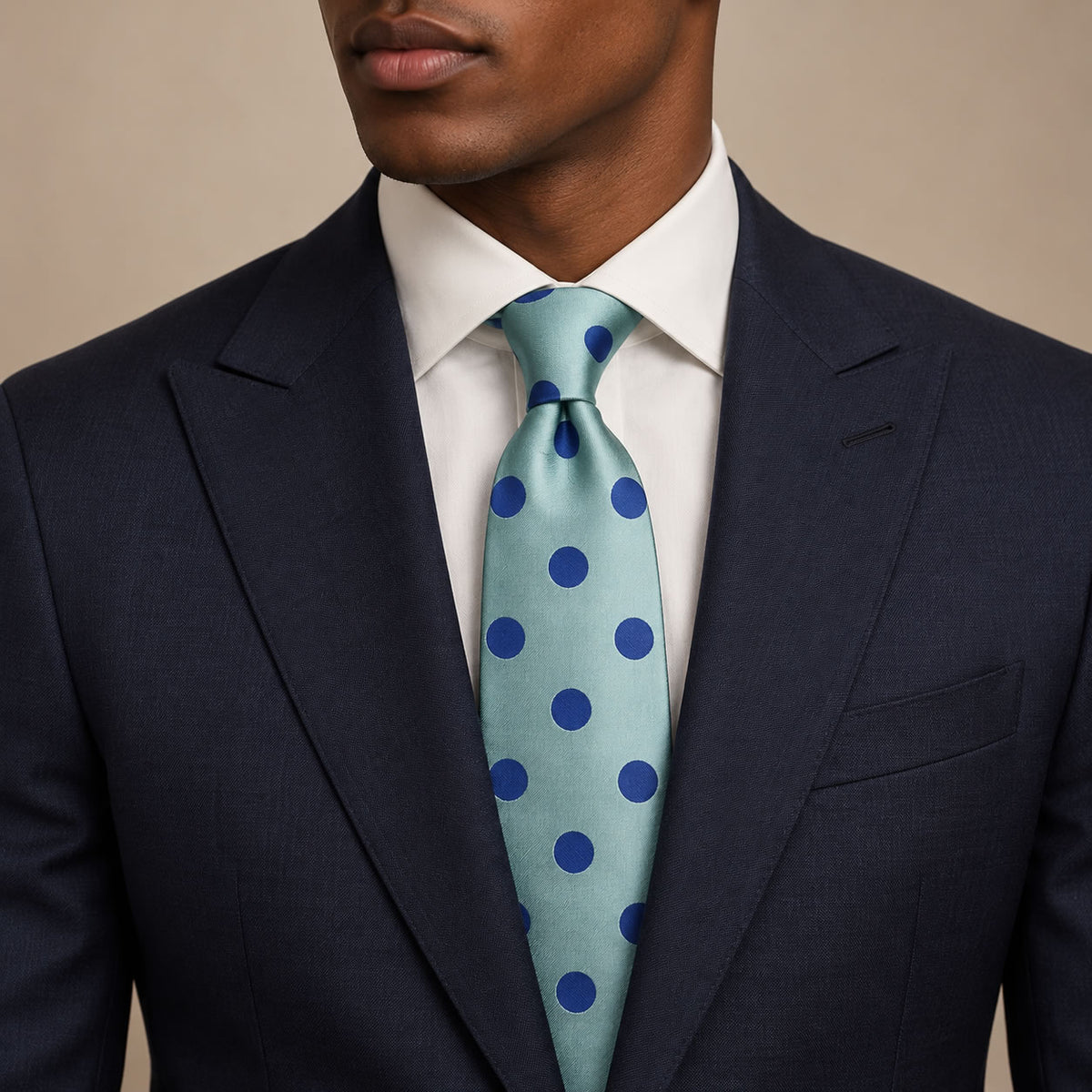 Blue Polka Dot Silk Tie by George Neale, worn by a model with a suit and shirt