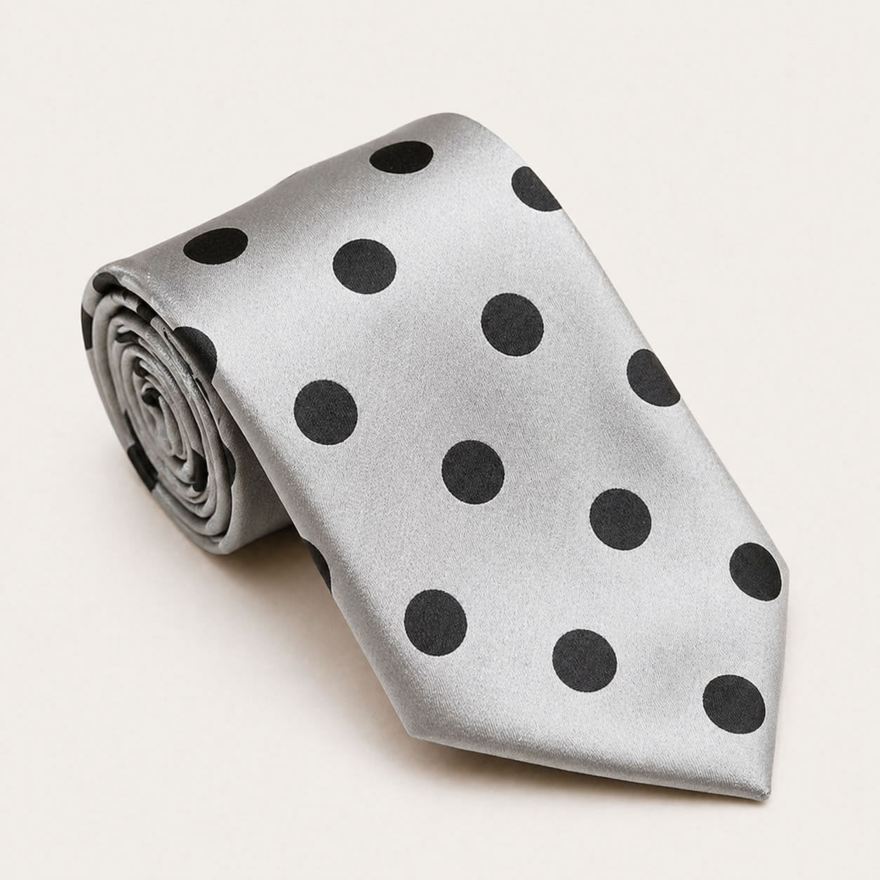 A rolled George Neale silver polka dot silk tie.