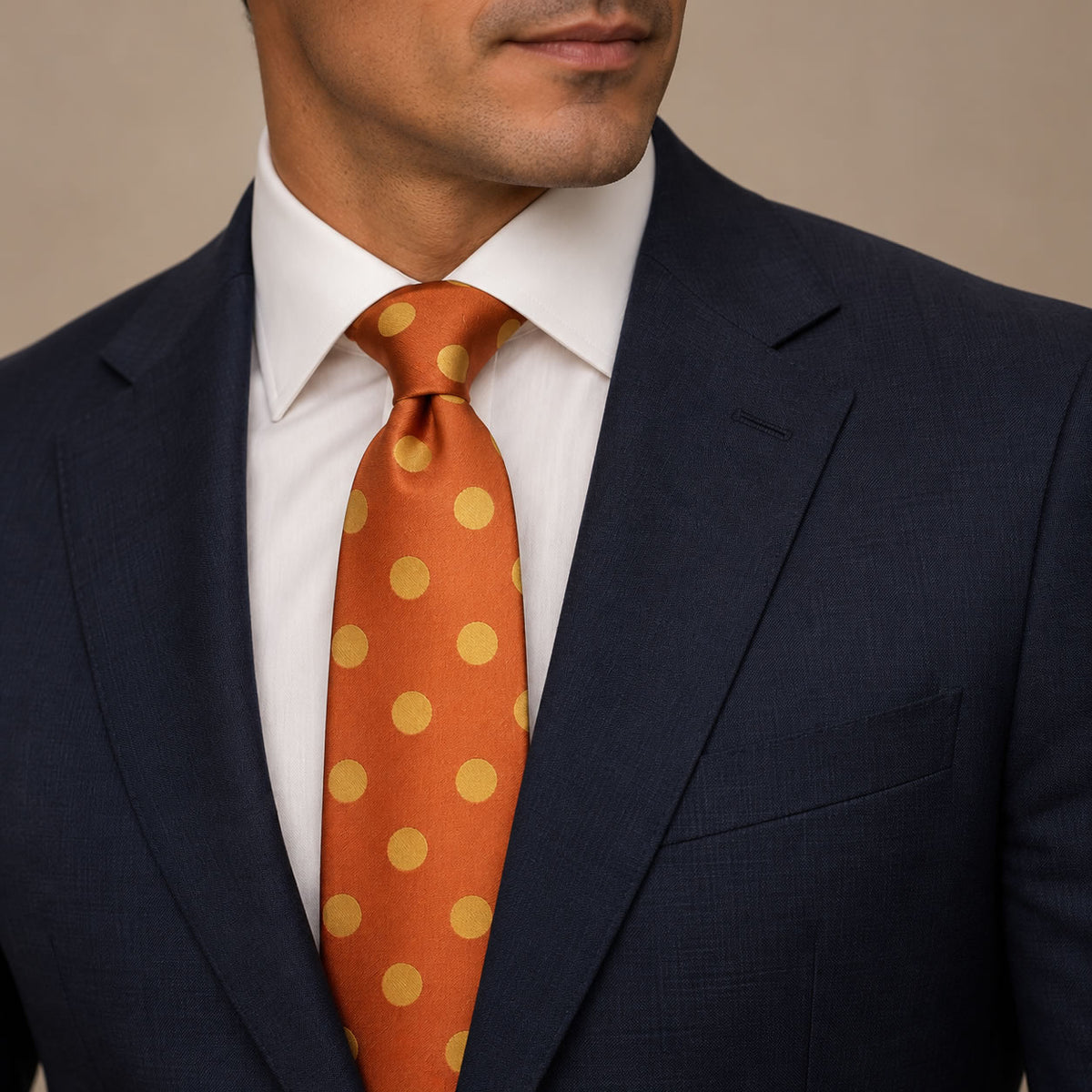 Orange and Gold Polka Dot Silk Tie by George Neale, worn by a model with a suit and shirt