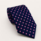 A rolled George Neale navy and pink polka dot silk tie.