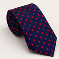 A rolled George Neale navy and red polka dot silk tie.