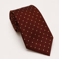 A rolled George Neale brown and gold polka dot silk tie.