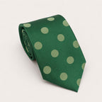 A rolled George Neale forest green polka dot silk tie.