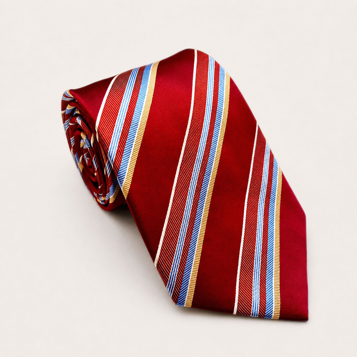 A rolled George Neale red and blue stripe silk tie.