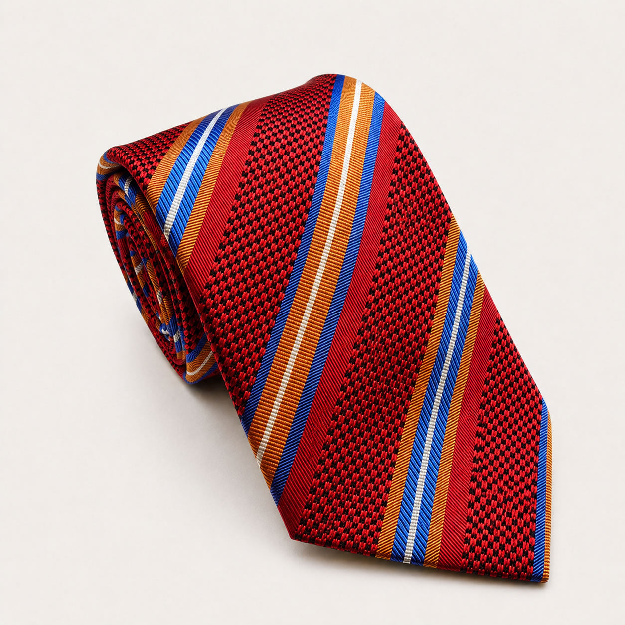 A rolled George Neale red and blue stripe silk tie.