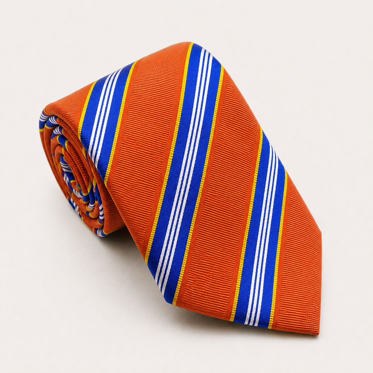 A rolled George Neale orange and blue stripe silk tie.