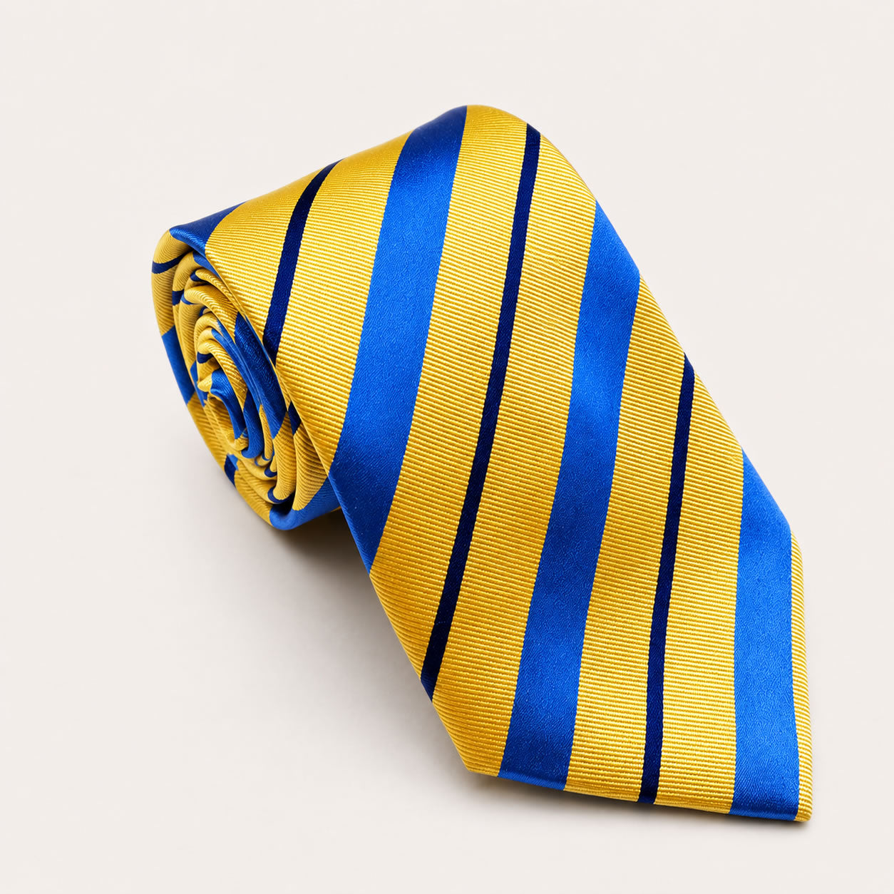 A rolled George Neale yellow and blue stripe silk tie.