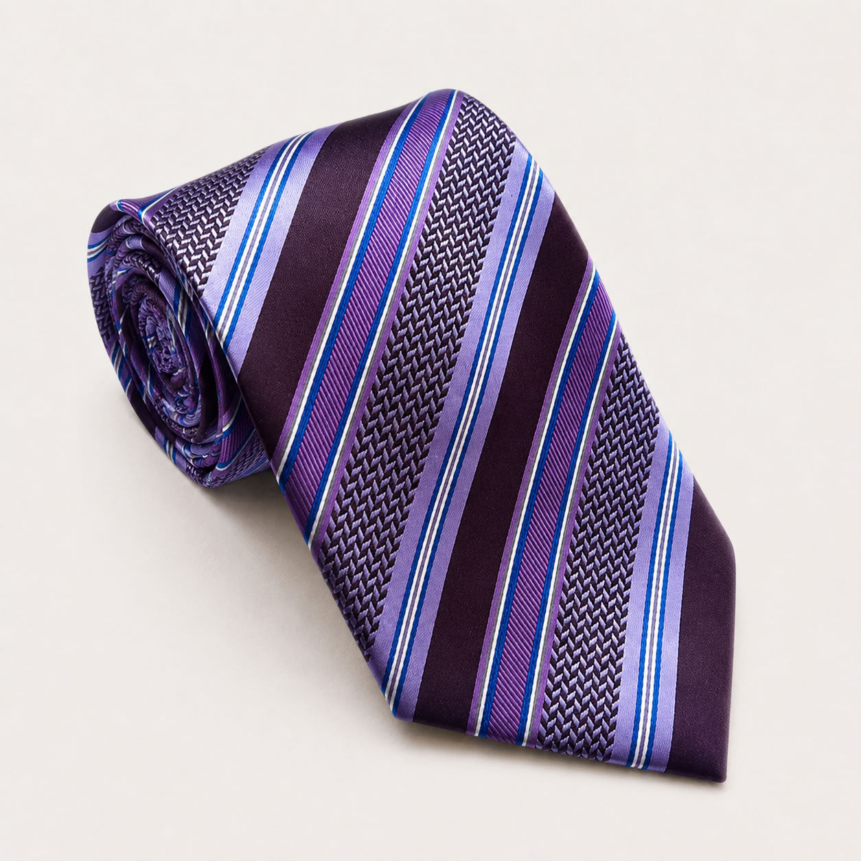 A rolled George Neale purple stripe silk tie.