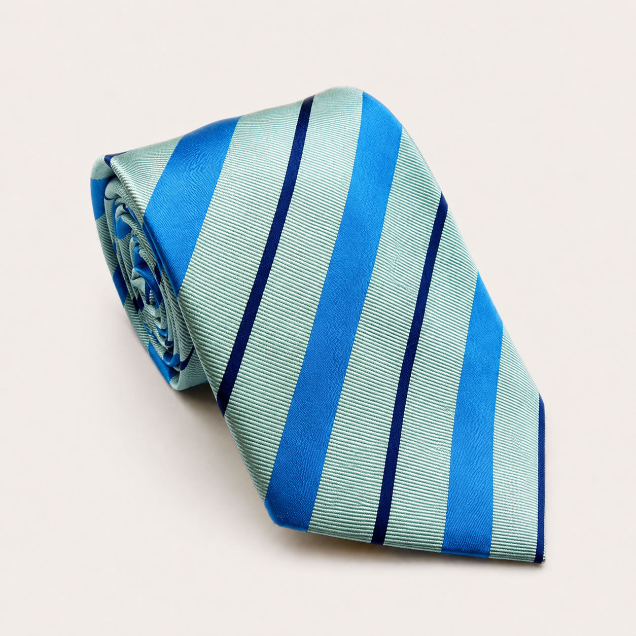 A rolled George Neale aquamarine stripe silk tie.