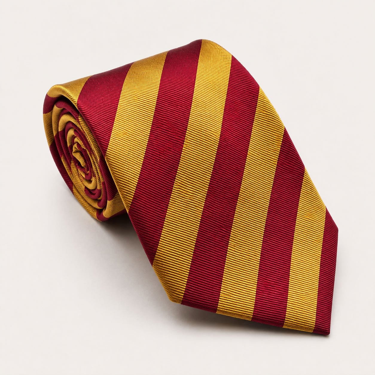 A rolled George Neale red and yellow stripe silk tie.
