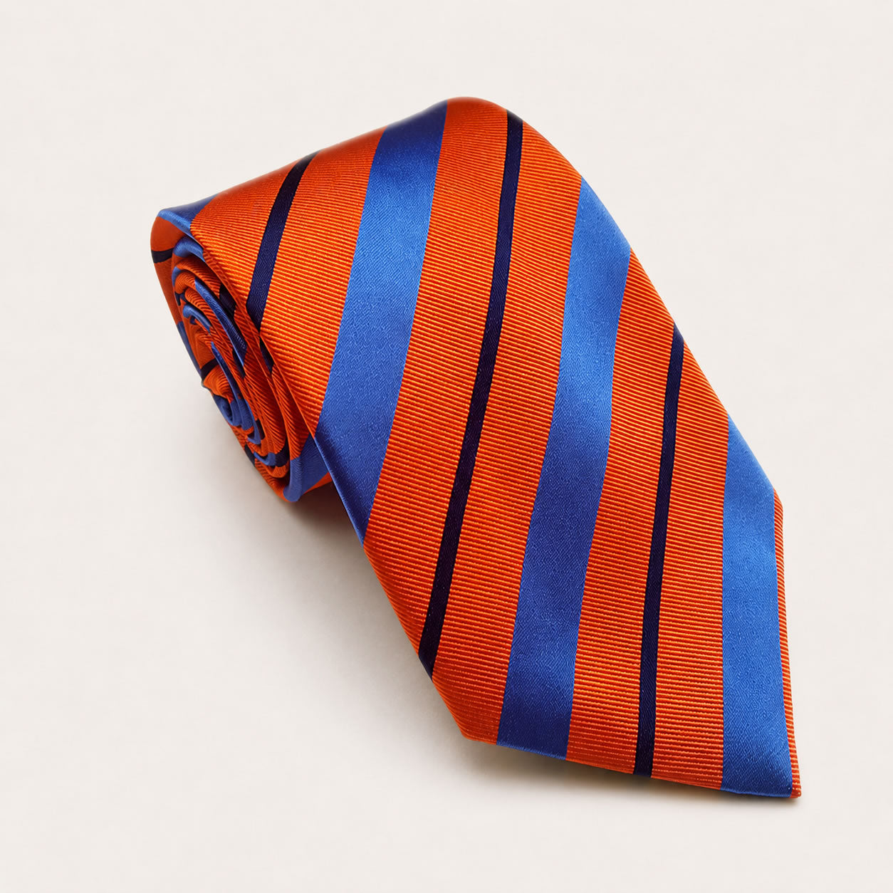 A rolled George Neale orange and blue stripe silk tie.